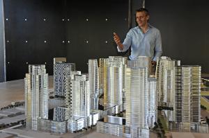 Nick Vanderboom, senior vice president of development for the Howard Hughes Corp, show a model of the company's plans to redevelop the 60 acres that is Ward Centers into a largely residential highrise community mixed with retail called Ward Village.