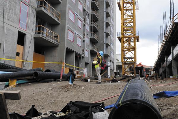 Workers are seen at the site of the first condominium tower at 801 South St., which is being built next to the former Honolulu Advertiser building. Developer Downtown Capital says all 410 units in the project's second tower have been sold to Hawaii residents.